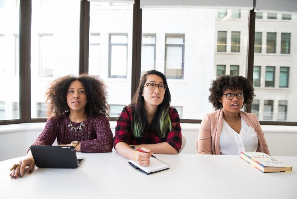 Three women sitting at a desk