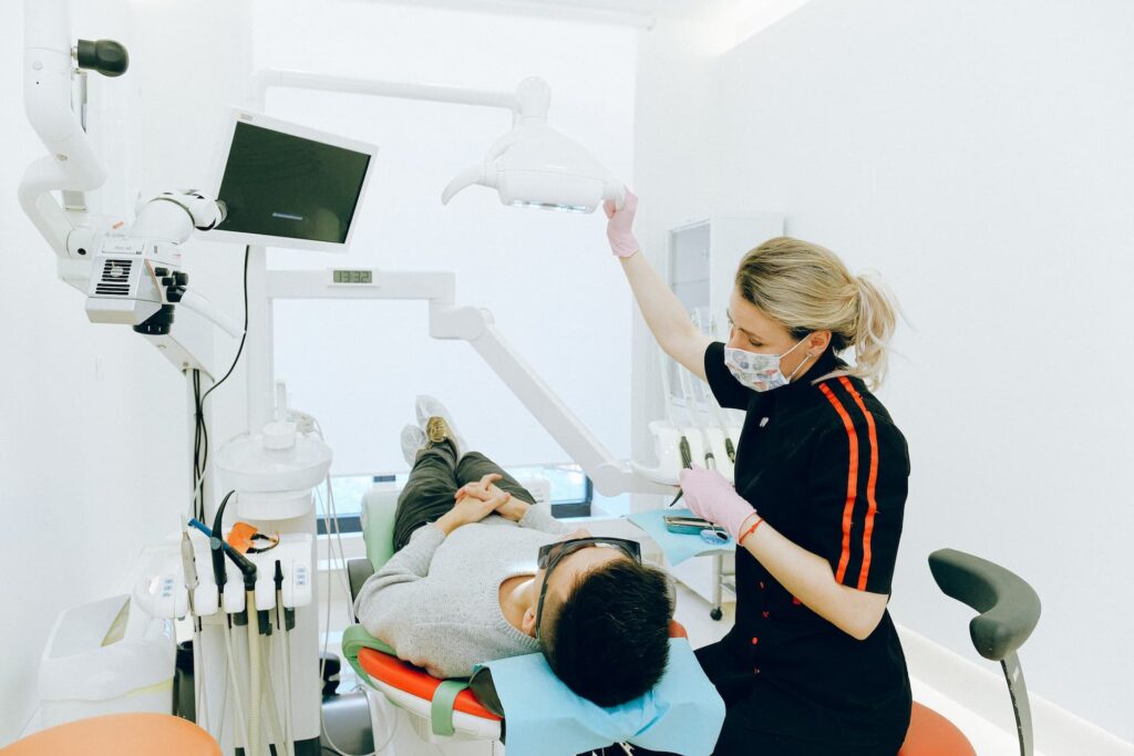 Dentist with patient lying back on chair