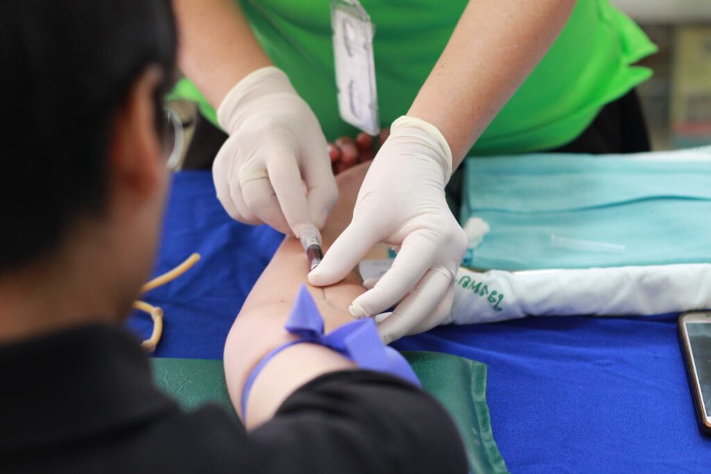 A nurse taking someone's blood sample