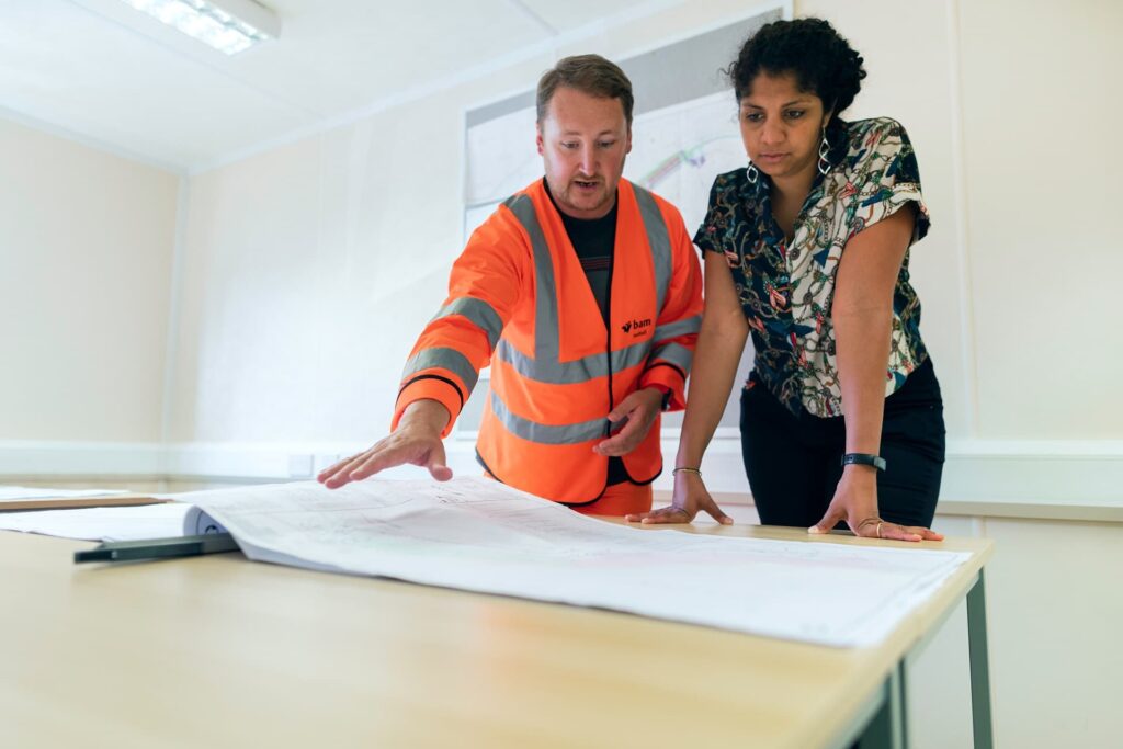 Man in high vis talking to Engineering Student